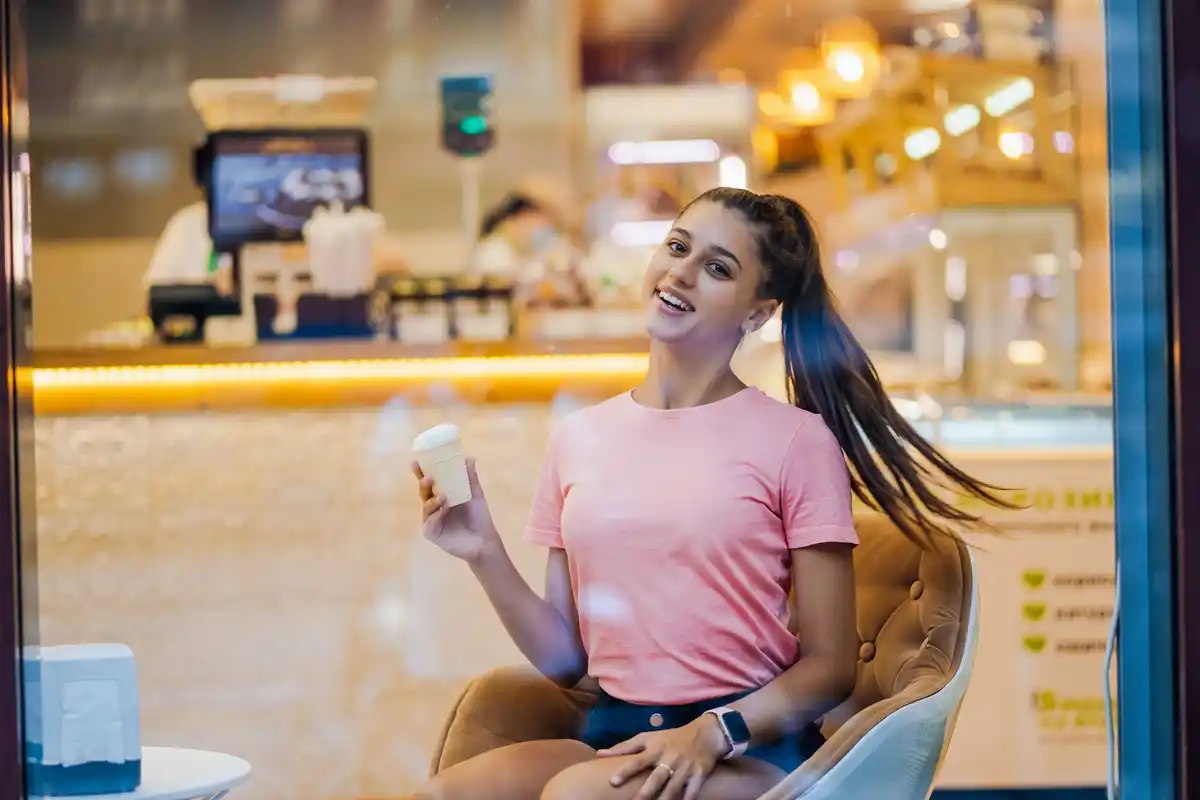 Young person paying with a smartwatch in cafe, czech