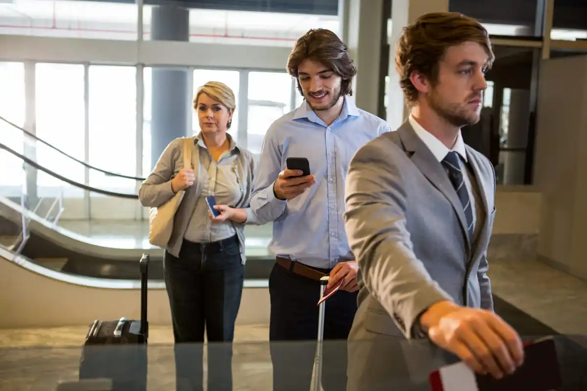 airport travelers comparing flight prices mobile laptop