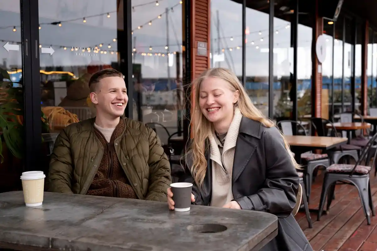 happy couple planning future finances at a Czech café