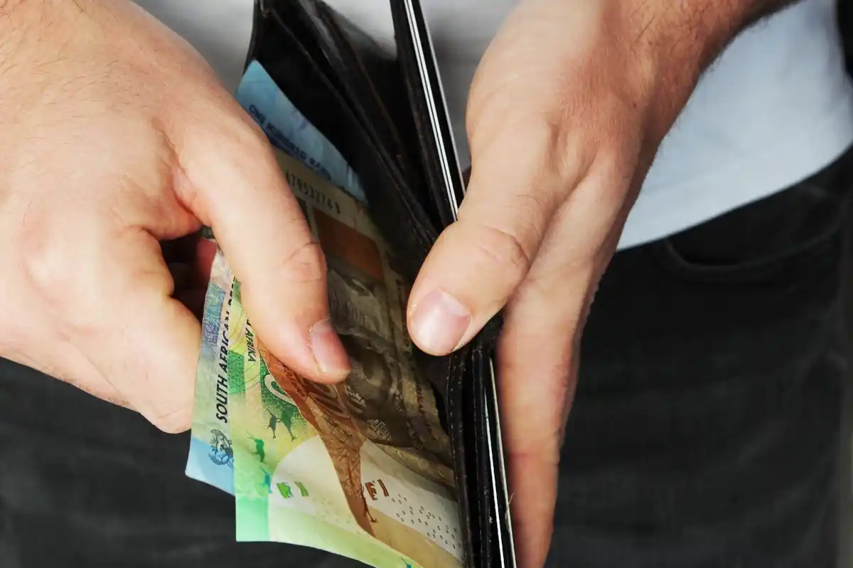 hand holding czech koruna banknotes in supermarket