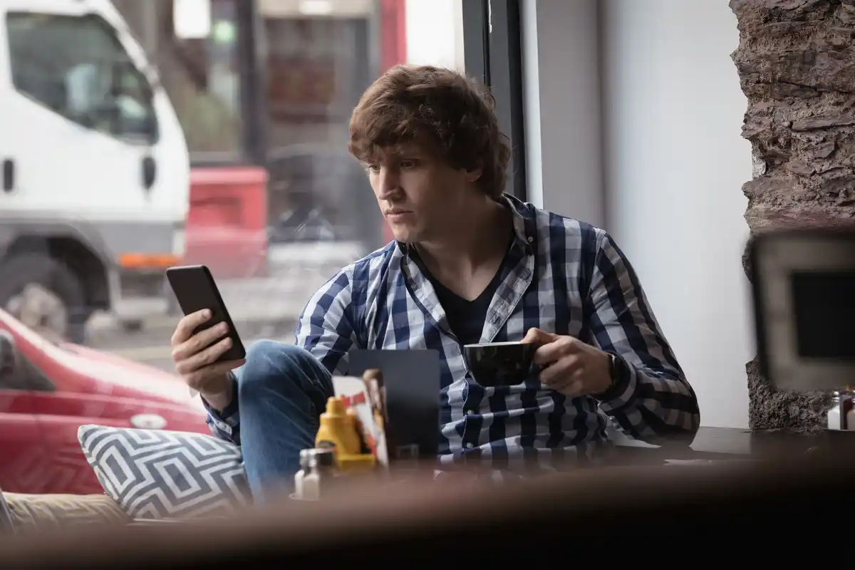 stressed person ignoring phone banking notification czech
