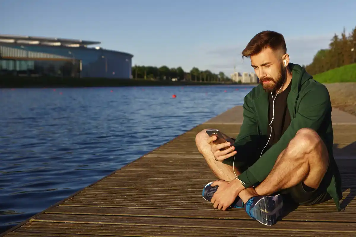 relaxed czech man in park not using smartphone money
