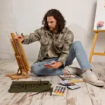 artist painting with improvised materials