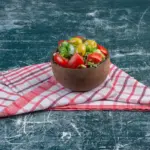 fresh salad stored in glass bowl with paper towel