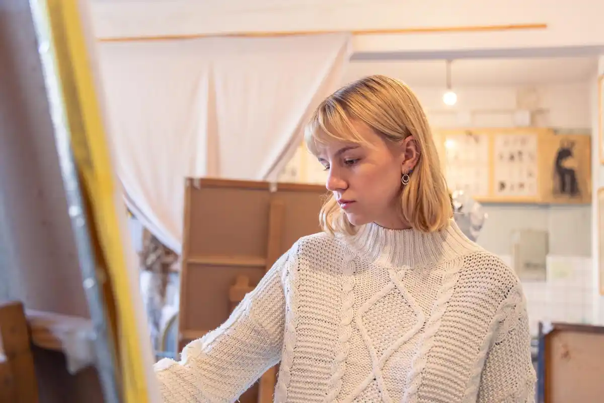 woman painting standing canvas older adult studio
