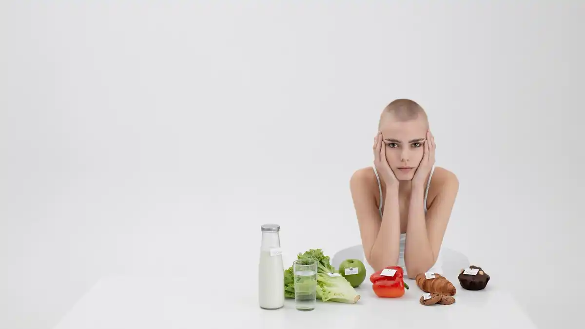sad woman eating low carb small salad scale measuring tape