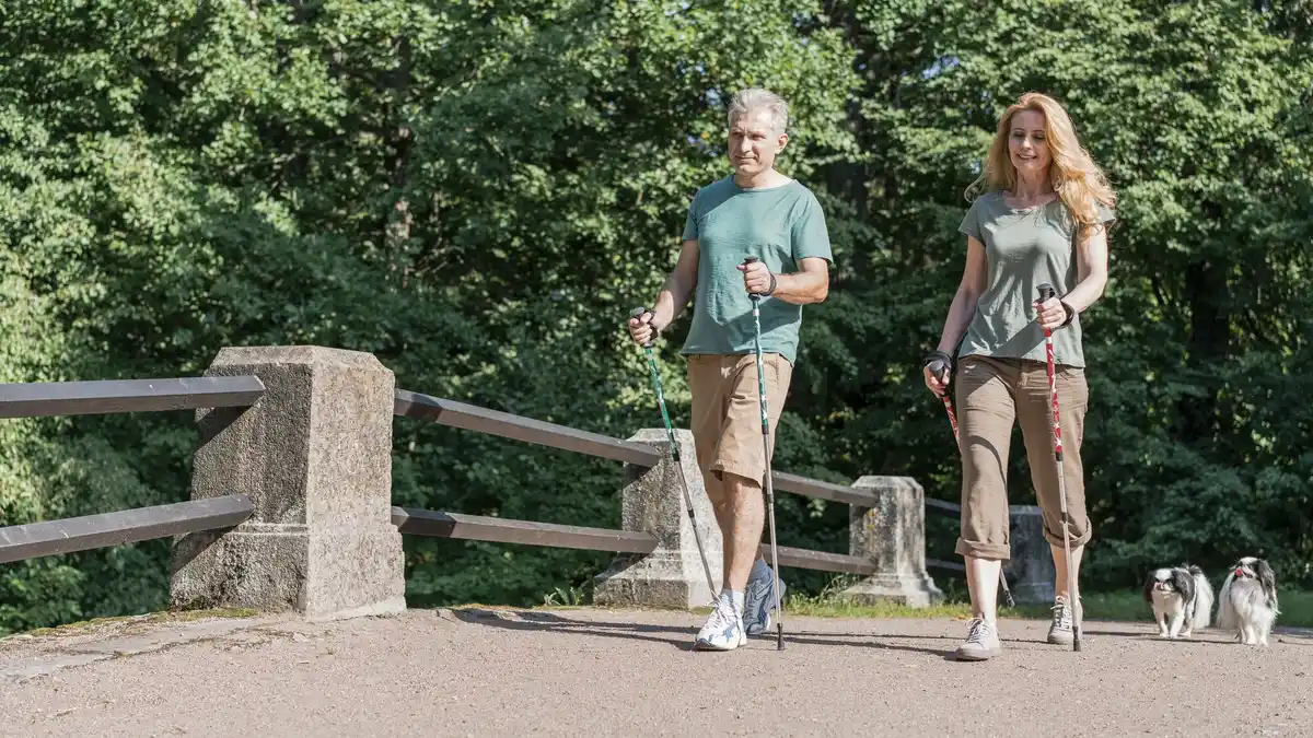 middle aged couple brisk walking Czech park