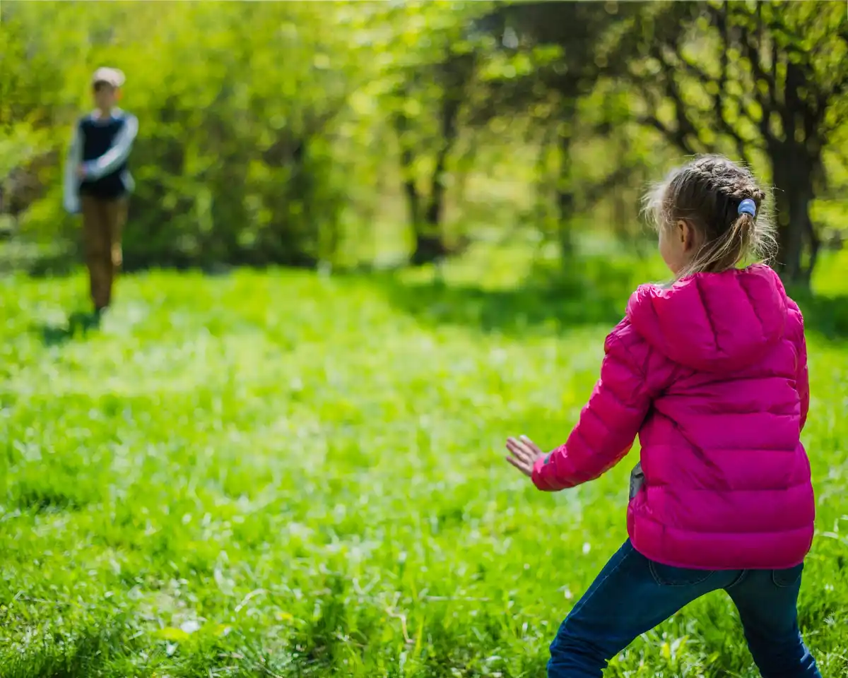laughing people walking backwards meadow