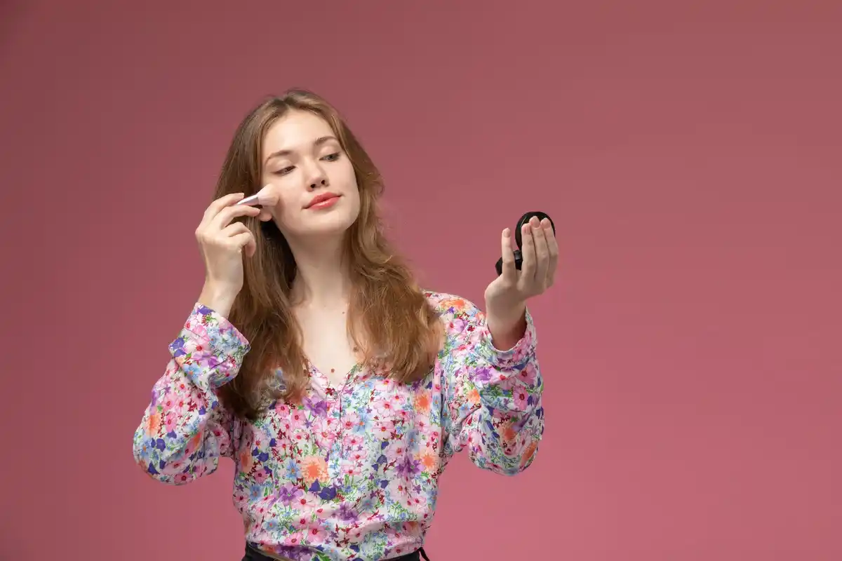 woman applying face cream upward motion