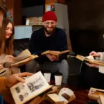czech family looking at old photo album living room