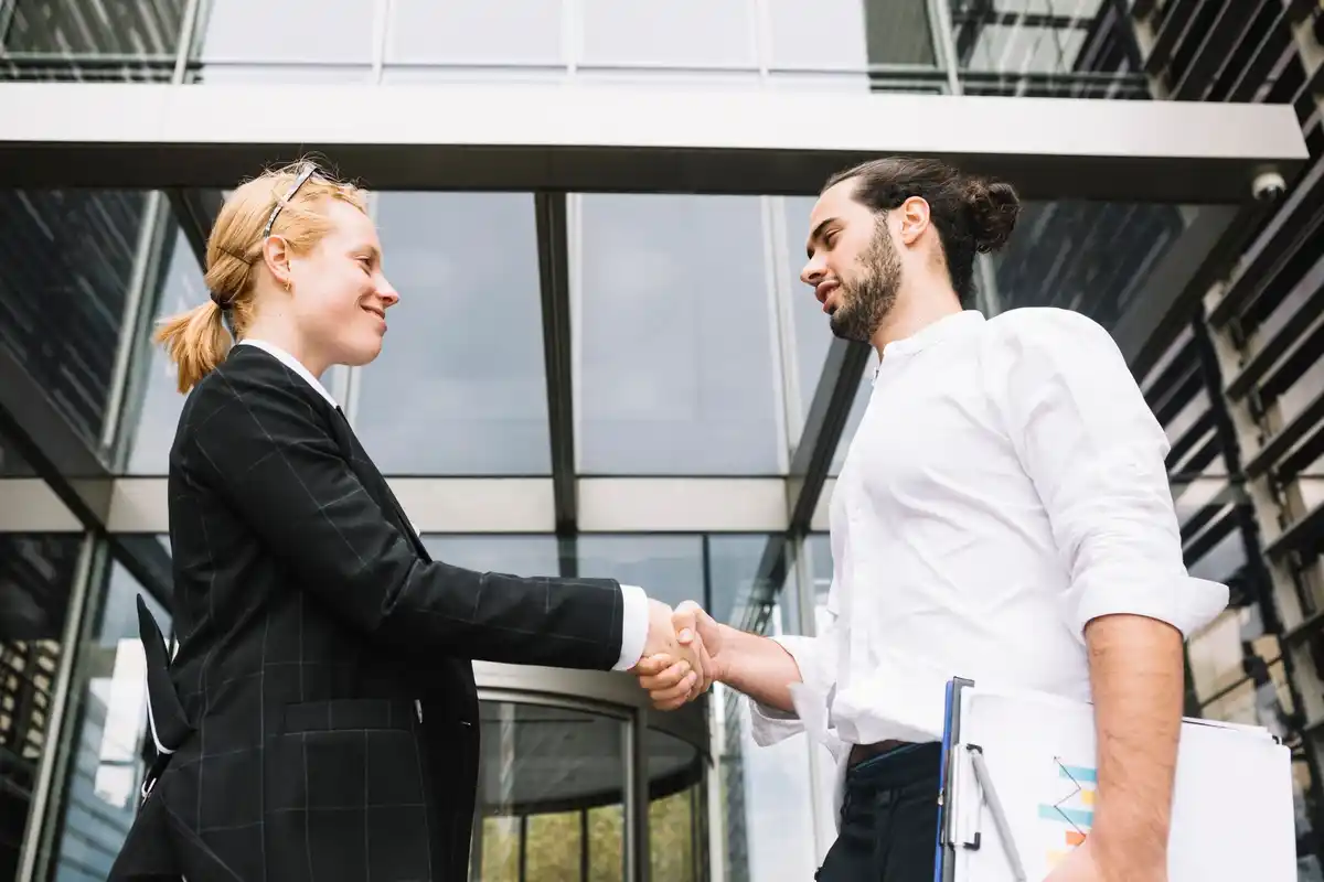 people shaking hands at business event introduction