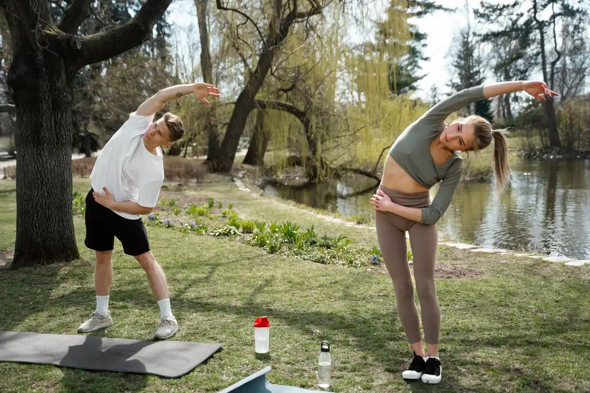 dynamic stretching group outdoors pre workout