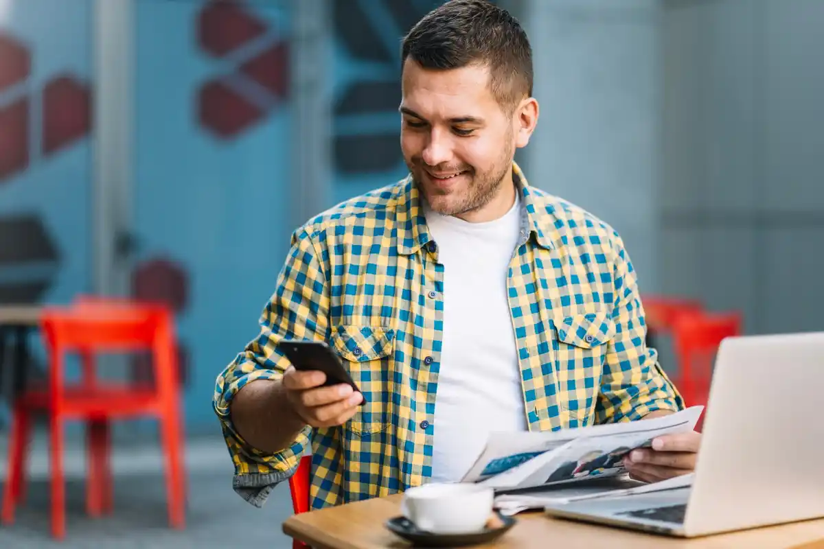 Happy Czech man checking online bank savings