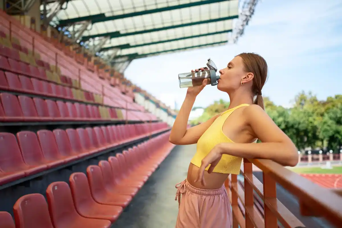 czech athlete drinking water during training