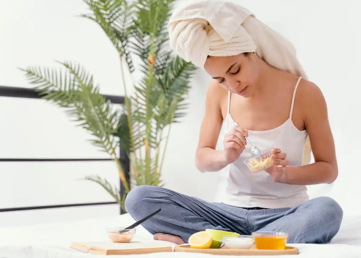 woman applying natural oil to face morning ritual