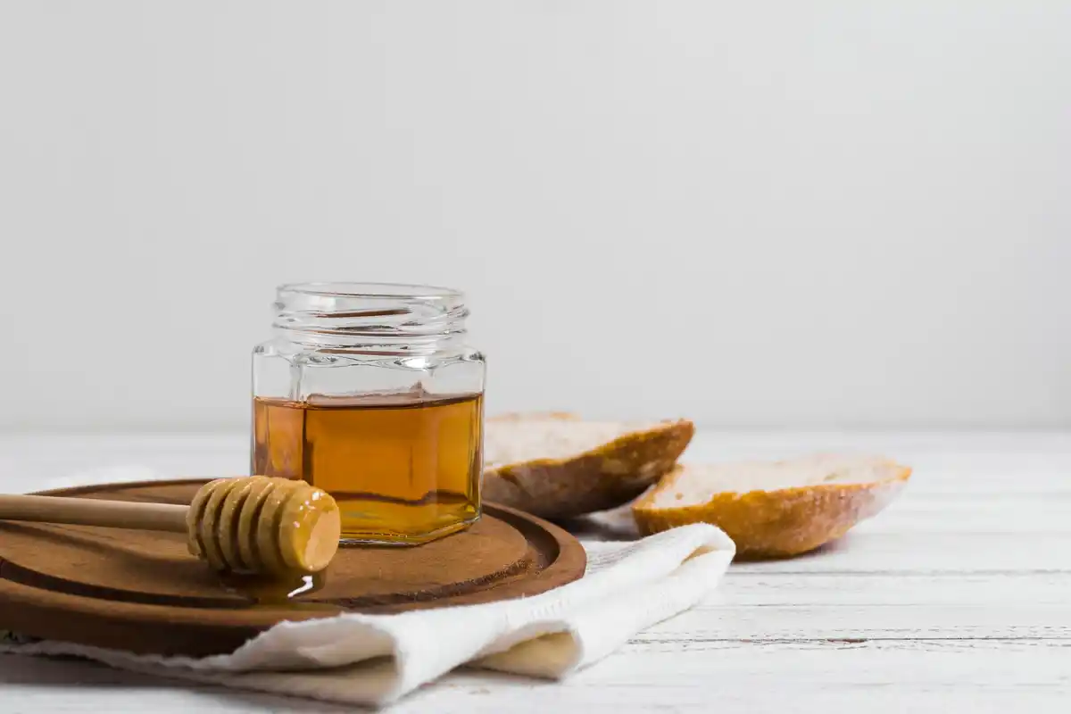 old crystallized honey jar on wooden table