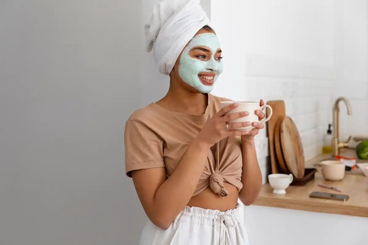 woman applying honey face mask home real life