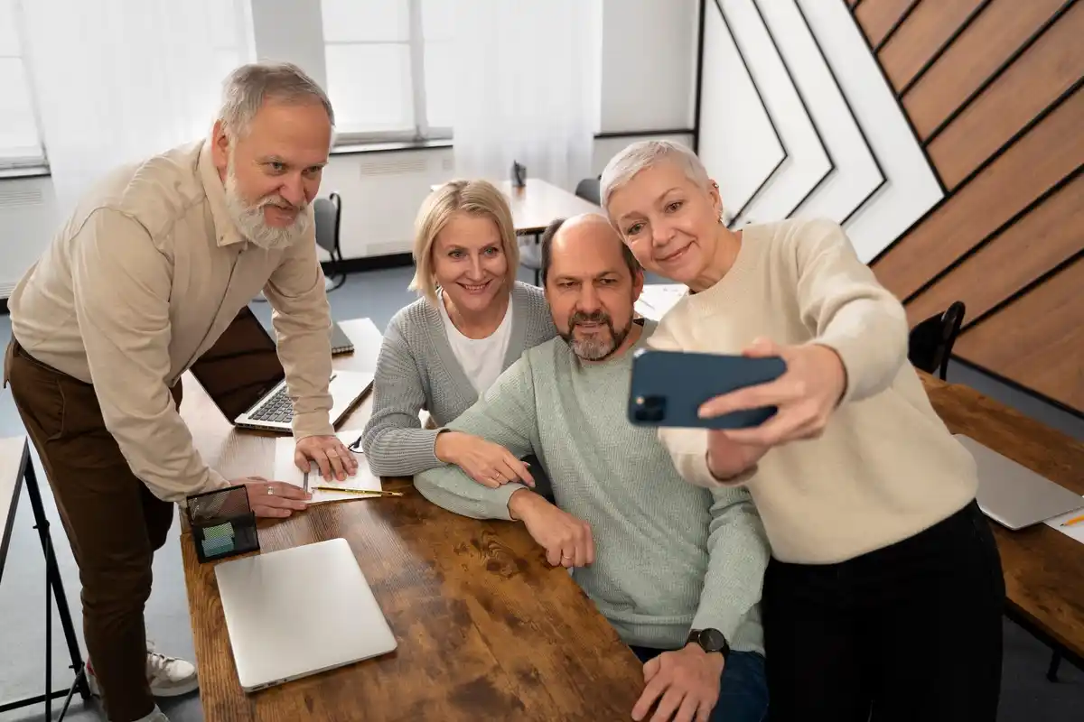 Czech seniors group using mobile phones together