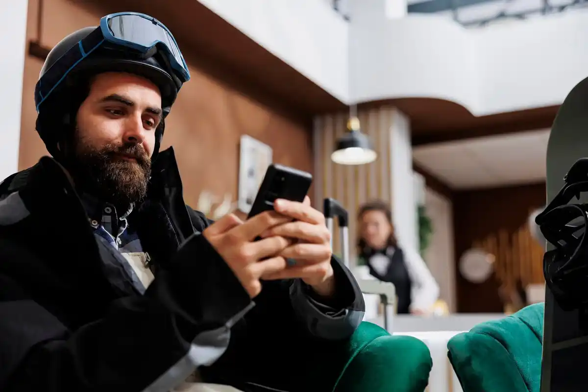 hacker stealing information from smartphone in cafe