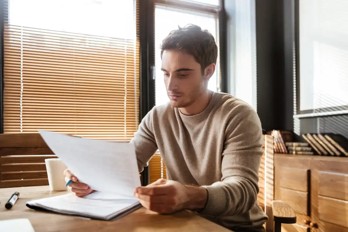 Czech person focused on work, paper task list, phone turned off