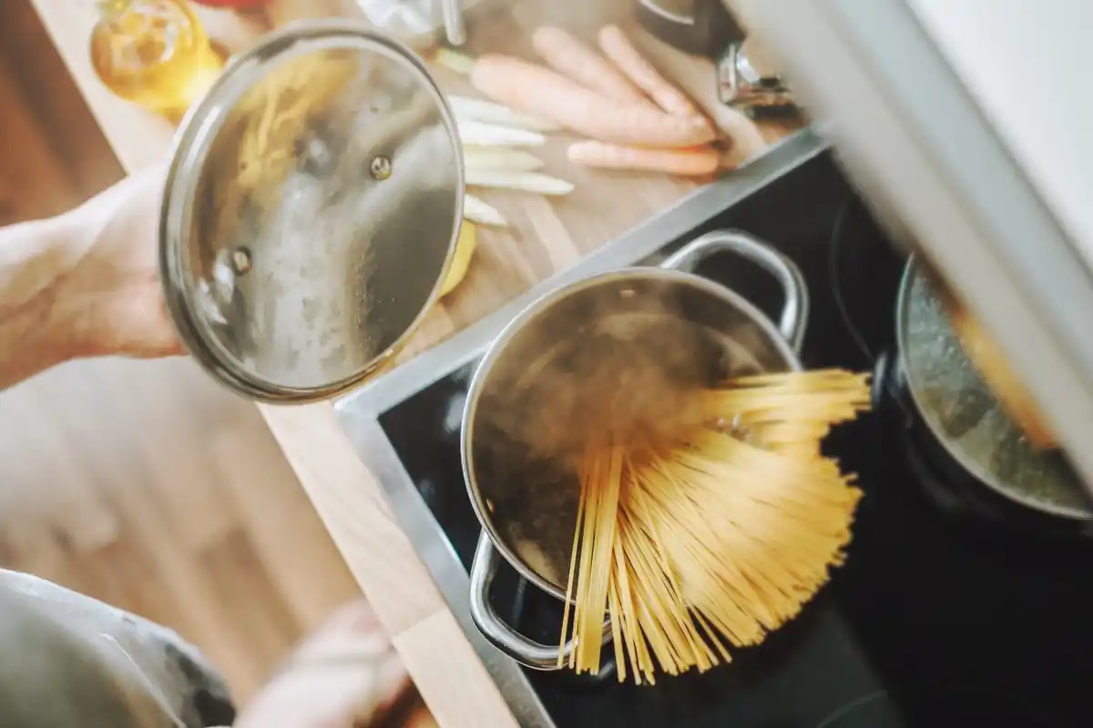 boiling pasta water visible steam home kitchen