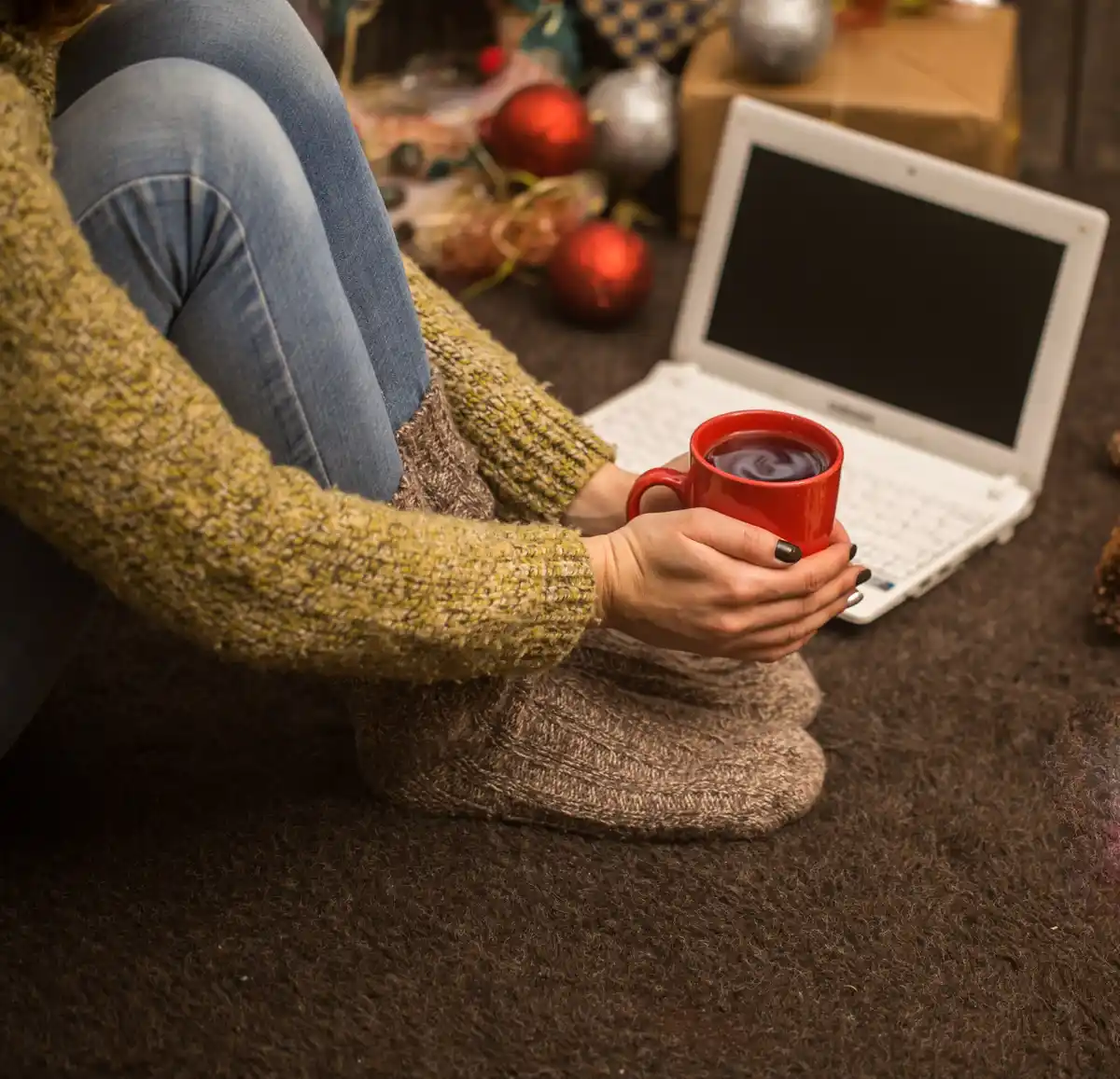 person opening laptop in cozy home office morning light