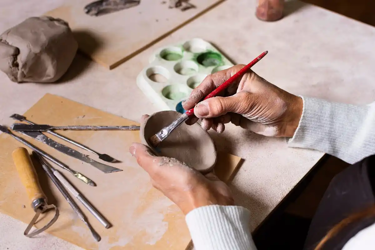 middle-aged woman starting pottery studio chechia city street